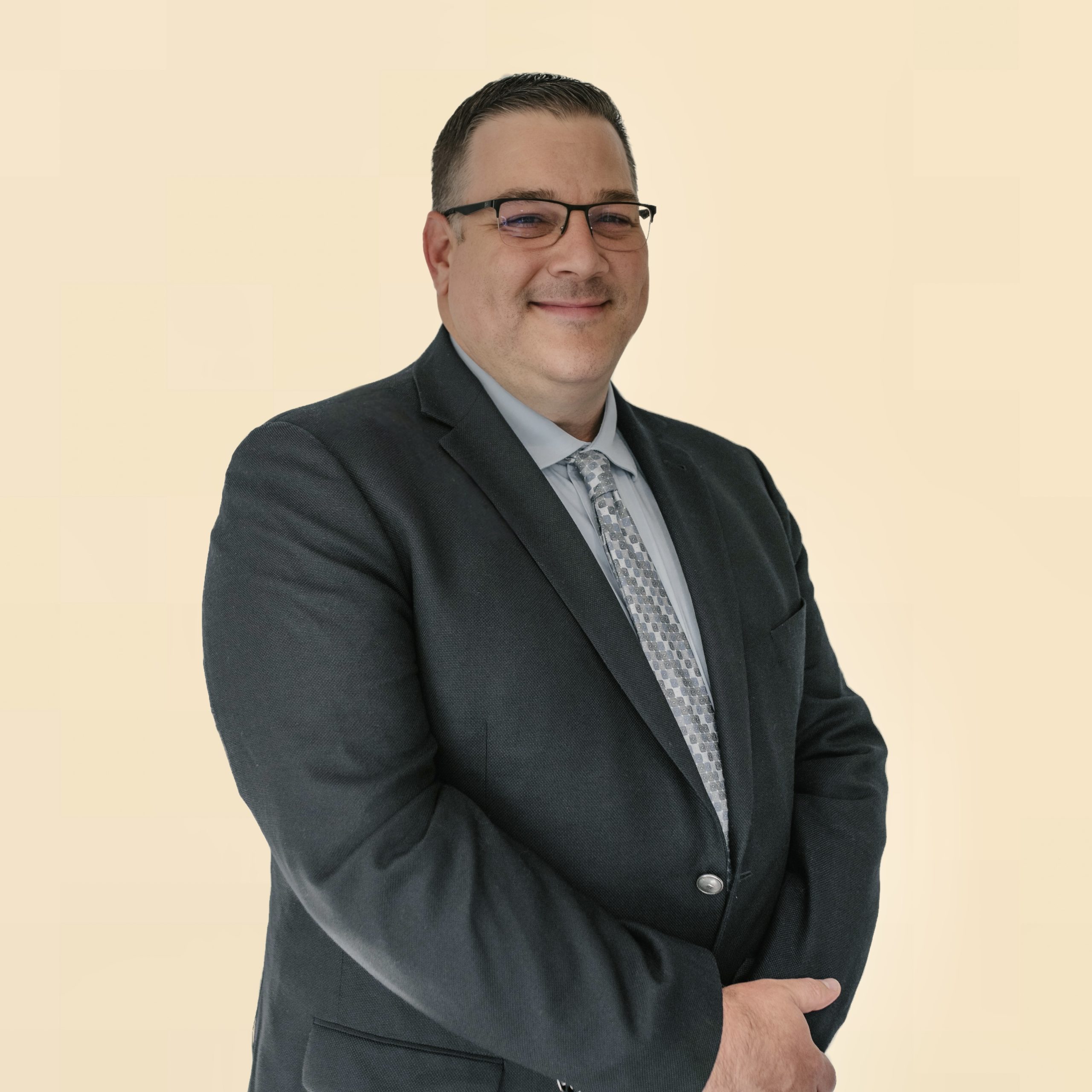 Man, in gray suit, with brown hair, smiling, in Jacksonville, Fl