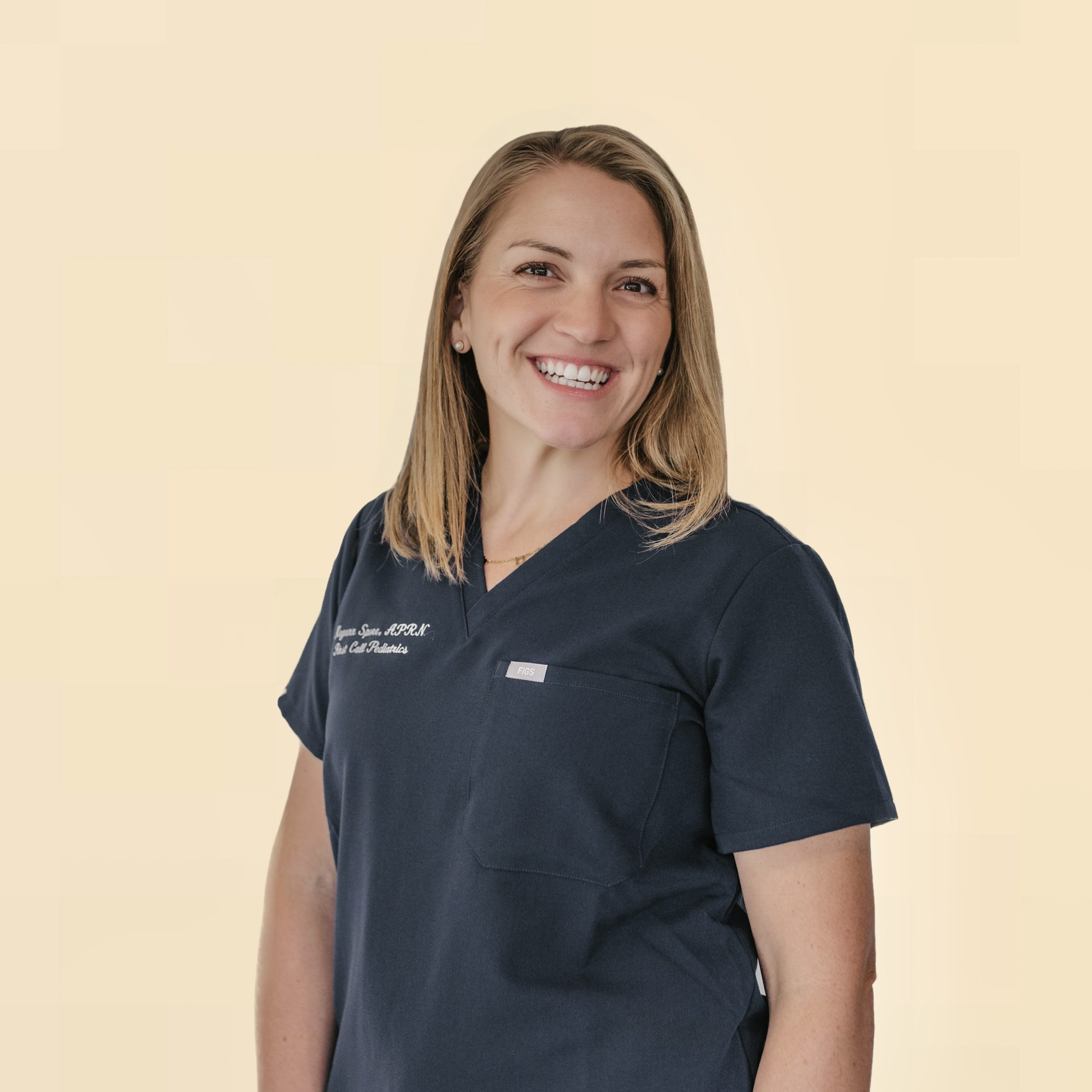 Blonde, straight-haired female NNP in First Call Pediatric Scrubs, smiling, wearing a stethoscope, in Jacksonville, Fl.