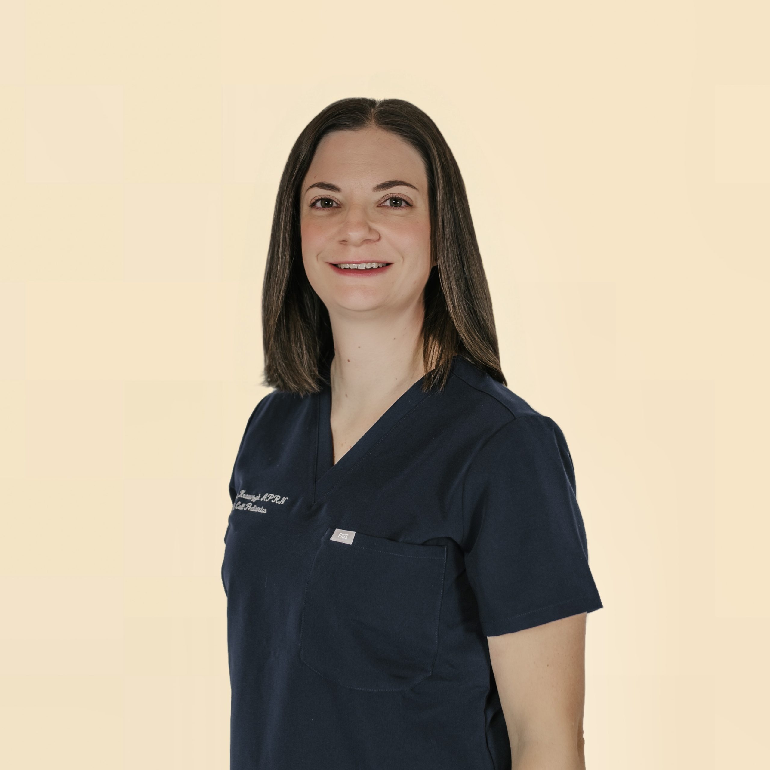 Brunette, straight haired female NNP in First Call Pediatric Scrubs, smiling, in Jacksonville, Fl.