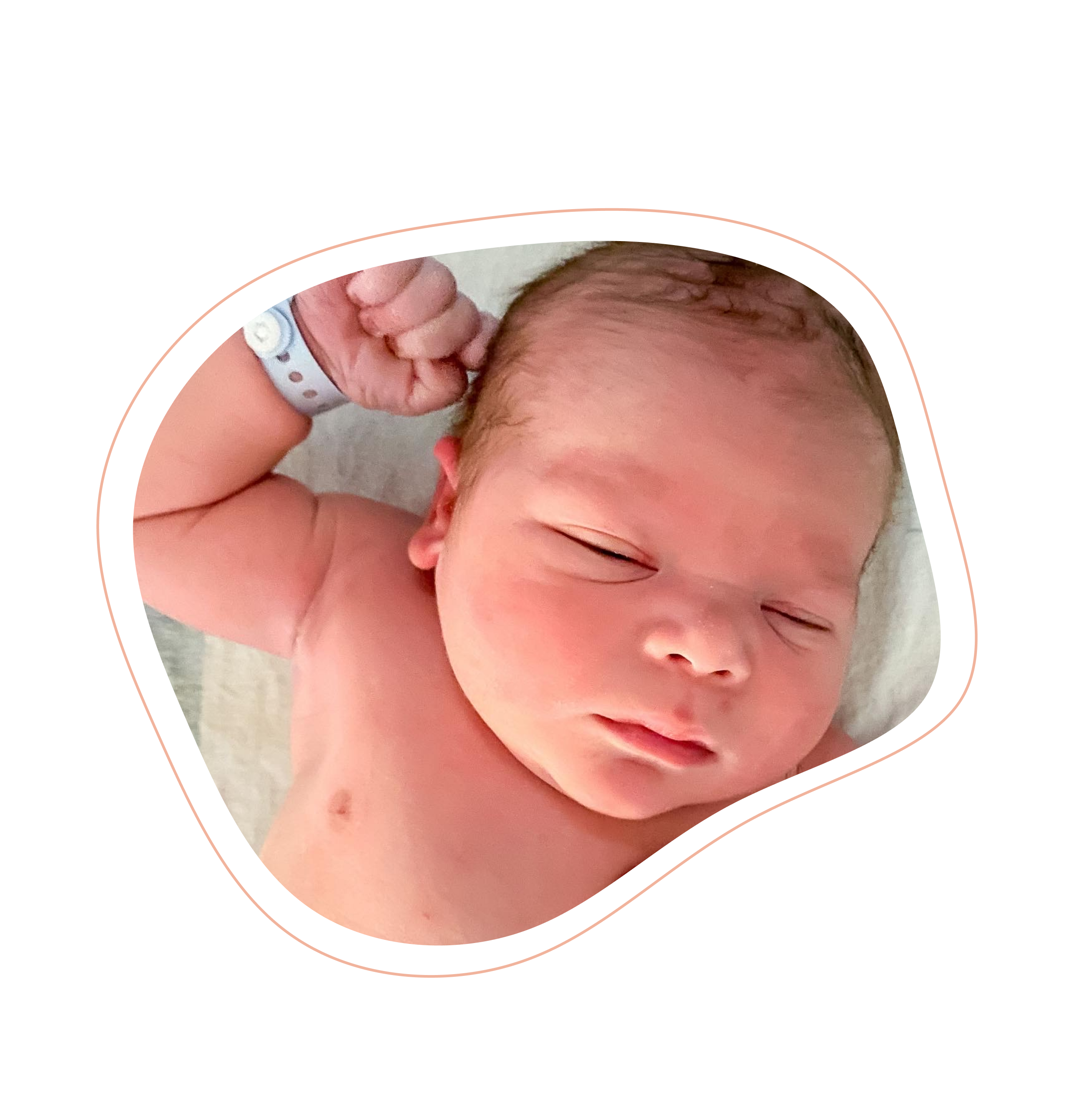 Newborn baby stretching out right arm, while laying on hospital blanket, at UF North Hospital, Jacksonville, FL