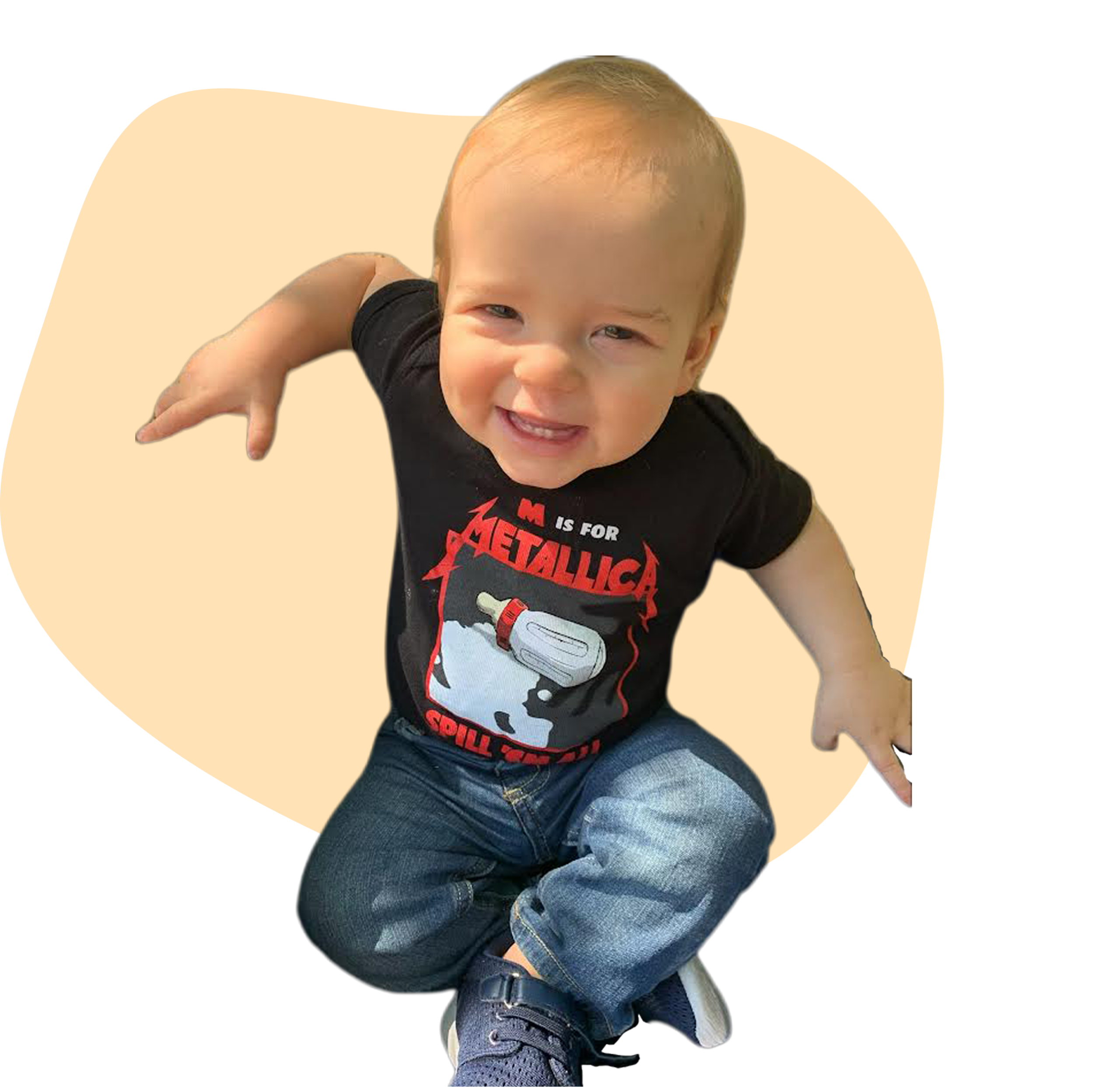 One-year-old boy in black t-shirt, jeans and blue sneakers, smiles, in Avondale, Jacksonville, Fl