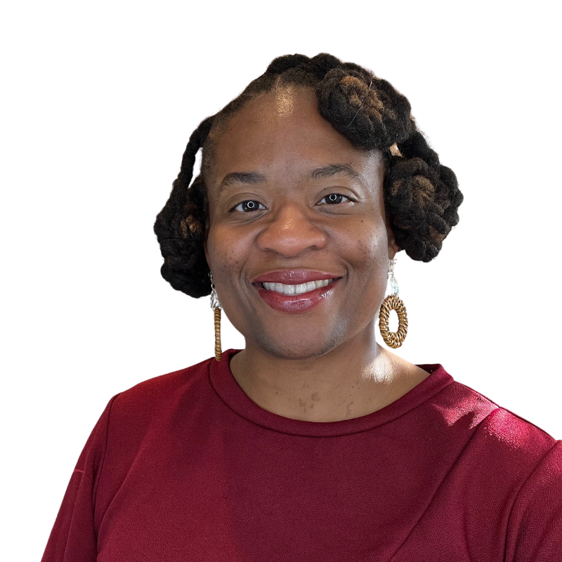 Woman with braided hair, in buns, with hoop earrings, and a red sweater, who is African American is smiling at camera